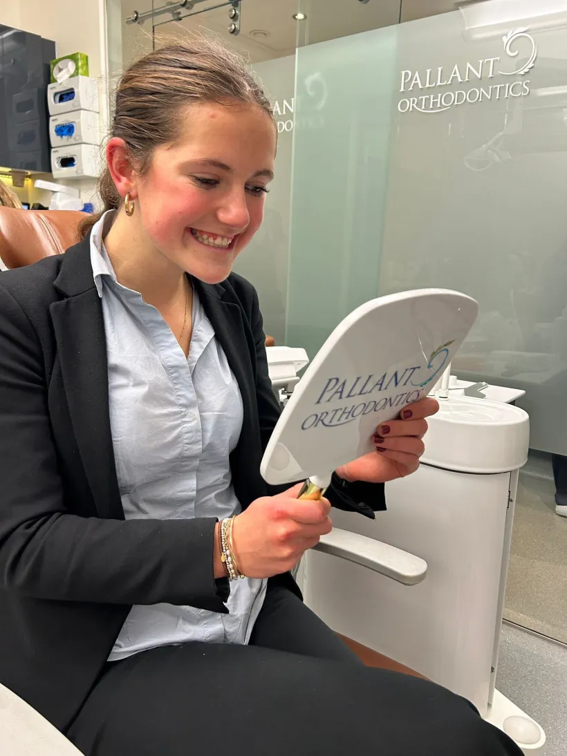 A teenage patient smiling with her completed orthodontic result